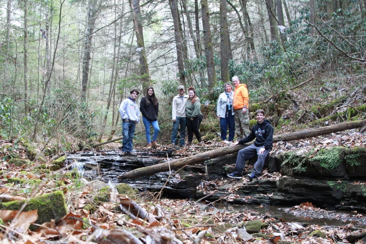 Maria with host family in woods